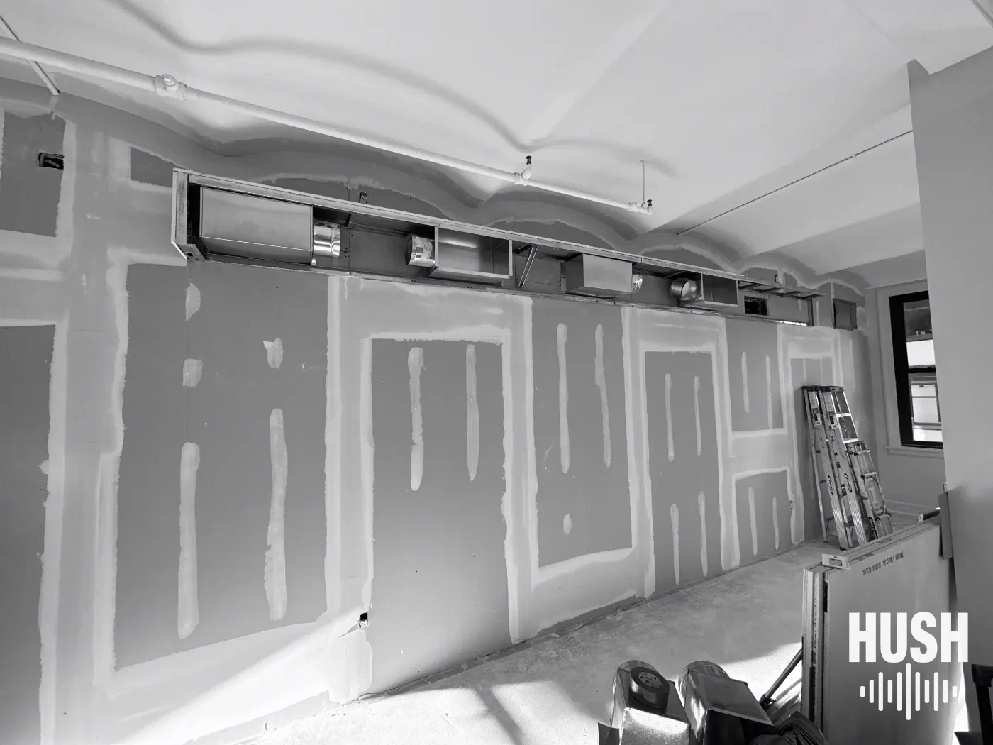 City soundproofing project with new drywall layers on a New York apartment wall